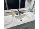 Contemporary bathroom vanity featuring quartz counters and sleek faucet at 2518 Sunset Ln, Lutz, FL 33559