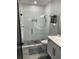 Stylish bathroom featuring a glass shower and modern fixtures at 2518 Sunset Ln, Lutz, FL 33559