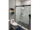 Modern bathroom featuring a glass-enclosed shower with gray stone floor and a sleek toilet at 2518 Sunset Ln, Lutz, FL 33559