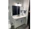 Well-lit bathroom with modern vanity, mirror, and fixtures at 2518 Sunset Ln, Lutz, FL 33559