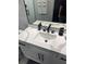 Bathroom vanity with quartz countertop, black hardware and fixtures at 2518 Sunset Ln, Lutz, FL 33559
