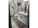 This bathroom features a sleek vanity, modern fixtures and glass walk-in shower at 2518 Sunset Ln, Lutz, FL 33559