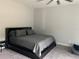 This bedroom features neutral walls, carpet, a ceiling fan and a queen-size bed at 2518 Sunset Ln, Lutz, FL 33559