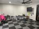 Spacious bonus room offers a flexible floor plan and checkerboard flooring at 2518 Sunset Ln, Lutz, FL 33559