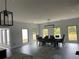 Bright dining room with wood floors, large windows, and a modern light fixture at 2518 Sunset Ln, Lutz, FL 33559