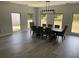 Bright dining room featuring a long table, ample windows, and neutral decor at 2518 Sunset Ln, Lutz, FL 33559