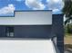 Modern exterior featuring a flat roof deck, offering a stylish design and outdoor space at 2518 Sunset Ln, Lutz, FL 33559
