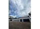 A modern-style home featuring black garage doors, white exterior, and contemporary architectural design at 2518 Sunset Ln, Lutz, FL 33559