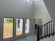 Bright foyer featuring high ceilings, large windows, and modern staircase design at 2518 Sunset Ln, Lutz, FL 33559