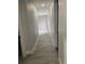 Bright hallway featuring modern flooring, crisp white trim, and neutral wall paint, illuminated by recessed lighting at 2518 Sunset Ln, Lutz, FL 33559