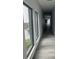 Bright hallway featuring modern flooring, crisp white trim, and neutral wall paint, with natural light streaming through at 2518 Sunset Ln, Lutz, FL 33559