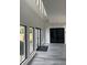Bright hallway featuring large windows, contemporary flooring, and sleek black doors and trim at 2518 Sunset Ln, Lutz, FL 33559