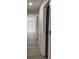 Long hallway featuring wood flooring and neutral decor at 2518 Sunset Ln, Lutz, FL 33559