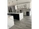 Contemporary kitchen featuring white and black cabinetry, quartz countertops, and stainless steel appliances at 2518 Sunset Ln, Lutz, FL 33559
