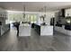 A large kitchen showcasing double islands with Quartz countertops, modern pendant lights, and open floorplan at 2518 Sunset Ln, Lutz, FL 33559
