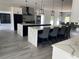 Open-concept kitchen boasting double islands with seating, modern appliances, and stylish pendant lighting at 2518 Sunset Ln, Lutz, FL 33559