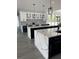 Bright and spacious kitchen featuring double islands with quartz countertops, gray backsplash, and glass-front cabinets at 2518 Sunset Ln, Lutz, FL 33559