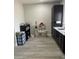 This room features a kitchenette with black cabinets, a stainless steel sink, and space for both cooking and play at 2518 Sunset Ln, Lutz, FL 33559