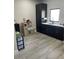 A kitchenette featuring dark cabinets, light countertops, and a stainless steel sink complemented by a play kitchen at 2518 Sunset Ln, Lutz, FL 33559