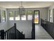 Second floor landing with natural light and modern lighting fixtures at 2518 Sunset Ln, Lutz, FL 33559
