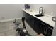 Functional laundry room featuring dark cabinets, sink, and countertop at 2518 Sunset Ln, Lutz, FL 33559