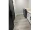 This view of the laundry room showcases modern appliances, sleek cabinets and wood-look flooring at 2518 Sunset Ln, Lutz, FL 33559