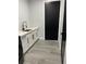This laundry room features a utility sink, storage, sleek cabinets and wood-look flooring at 2518 Sunset Ln, Lutz, FL 33559