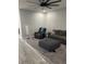 Spacious living room with plush seating, a ceiling fan, and modern decor, offering a comfortable and inviting atmosphere at 2518 Sunset Ln, Lutz, FL 33559