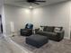 Inviting living room showcases a comfortable sofa, recliner, ottoman, and stylish decor, perfect for relaxation at 2518 Sunset Ln, Lutz, FL 33559