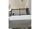 View of the interior loft featuring dark wood railing and open space at 2518 Sunset Ln, Lutz, FL 33559
