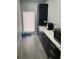 Pantry features gray tile floor, black cabinets, and a window for natural light at 2518 Sunset Ln, Lutz, FL 33559
