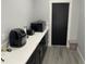 Modern pantry featuring black cabinets, bright countertops, and convenient appliance storage space at 2518 Sunset Ln, Lutz, FL 33559