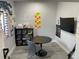 A well-lit room with a round table, colorful decorations, and educational posters, perfect for learning and creativity at 2518 Sunset Ln, Lutz, FL 33559