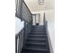 Modern staircase with black railings leading to the second level at 2518 Sunset Ln, Lutz, FL 33559