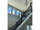 Bright staircase with black railing and oversized windows offers natural light at 2518 Sunset Ln, Lutz, FL 33559