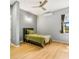 Contemporary bedroom features a ceiling fan and a window with a verdant view at 5479 S Biscayne Dr, North Port, FL 34287