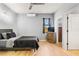 Bedroom featuring a ceiling fan, window, dresser, and an attached bathroom at 5479 S Biscayne Dr, North Port, FL 34287
