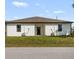 New construction home with a brown roof, impact windows, and a green lawn at 5479 S Biscayne Dr, North Port, FL 34287