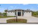 Stunning single-story home featuring a modern exterior, fresh landscaping, and a spacious driveway at 5479 S Biscayne Dr, North Port, FL 34287