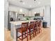 Well-lit kitchen with gray cabinetry, stainless steel appliances, and a large island with seating at 5479 S Biscayne Dr, North Port, FL 34287