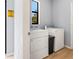 Bright laundry room features white washer and dryer with a window view to outside at 5479 S Biscayne Dr, North Port, FL 34287
