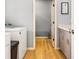 Well-lit laundry area has gray cabinets and a view to another room at 5479 S Biscayne Dr, North Port, FL 34287