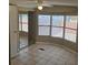 Bright bedroom featuring tile flooring, large windows, and a mirrored closet, offering ample natural light at 9202 Teak St, New Port Richey, FL 34654