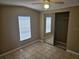 Cozy bedroom features tile flooring, closet with mirrored doors, and a ceiling fan at 9202 Teak St, New Port Richey, FL 34654