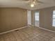 Bedroom with tile flooring and natural light, featuring a closet and exterior door at 9202 Teak St, New Port Richey, FL 34654