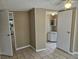 Bedroom view into bathroom and kitchen area with tile flooring at 9202 Teak St, New Port Richey, FL 34654