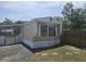 Cozy home with a covered entrance and a charming exterior design on a sunny day at 9202 Teak St, New Port Richey, FL 34654