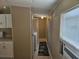 Hallway with tile flooring and air conditioning unit in view of the laundry room and kitchen at 9202 Teak St, New Port Richey, FL 34654