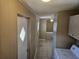 Hallway featuring tile flooring, with access to the laundry area and an exterior door at 9202 Teak St, New Port Richey, FL 34654