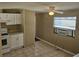 The kitchen area with tile flooring, window AC unit, and white appliances offers a practical space at 9202 Teak St, New Port Richey, FL 34654